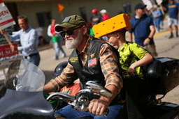 Rep. Derrick Van Orden, R-Wis., a candidate for Wisconsin's 3rd Congressional district, rides a motorcycle with his grandson in a Labor Day parade, Monday, Sept. 7, 2026, in Readstown, Wis. (AP Photo/Ellen Schmidt)