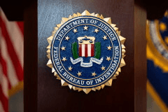 An FBI seal is displayed on a podium before a news conference at the field office in Portland, Ore., Jan. 16, 2025. (AP Photo/Jenny Kane, File)