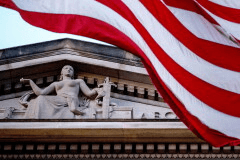 An American flag flies outside the Department of Justice in Washington, March 22, 2019. (AP Photo/Andrew Harnik, File)