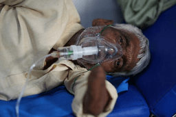 A patient receiving oxygen lies on a hospital bed while suffering from a heat-related illness amid high temperatures during a heat wave in Banda, northern Indian state of Uttar Pradesh, Friday, June 19, 2026. (AP Photo/Rajesh Kumar Singh)