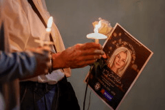 Community members hold candles as they gather for a vigil honoring the life of Iryna Zarutska, who was fatally stabbed on a commuter train, Sept. 22, 2025, in Charlotte, N.C. (AP Photo/Nell Redmond, File)