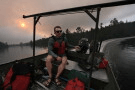 Willy Vosburgh, owner of Vosburgh's Custom Cabin Rentals on Moose Lake, uses a tow boat to evacuate canoeists from the Boundary Waters Canoe Area Wilderness after multiple wildfires burning there prompted its closure and evacuation Tuesday, July 14, 2026 in Ely, Minn. (Anthony Souffle/Minnesota Star Tribune via AP)