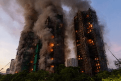 Smoke rises after a fire broke out at Wang Fuk Court, a residential estate in the Tai Po district of Hong Kong's New Territories, Nov. 26 2025. (AP Photo/Chan Long Hei, File)