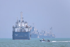 A small motorboat passes anchored vessels in the Strait of Hormuz off Bandar Abbas, Iran, Thursday, June 11, 2026.(Amirhosein Khorgooi/ISNA via AP)