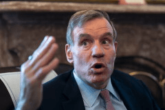 Sen. Mark Warner, D-Va., the vice chair of the Senate Intelligence Committee, speaks to reporters about FISA, the law that allows the U.S. to gather intelligence abroad, at the Capitol in Washington, Thursday, June 11, 2026. (AP Photo/J. Scott Applewhite)