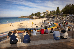 People sit on stairs at Coogee beach following a shark attack in Sydney, Saturday, June 13, 2026. (Nadir Kinani/AAP Image via AP)