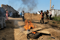 Rubble set on fire as health and frontline workers protest at the Elikya Ebola Treatment Center in Bunia, Congo, on Saturday, July 25, 2026. (AP Photo/Constant Same Bagalwa)